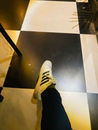 Selfie of sneakers on the floor in a modern shopping center.の写真素材