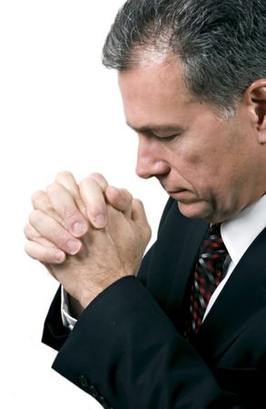 Man with hands folded and head bowed in a posture of prayer.の写真素材