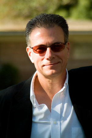 Smiling, happy man wearing sunglasses and black jacketの写真素材