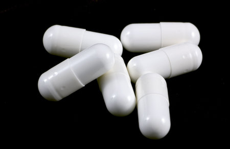A group of pills, taken over a black cloth.