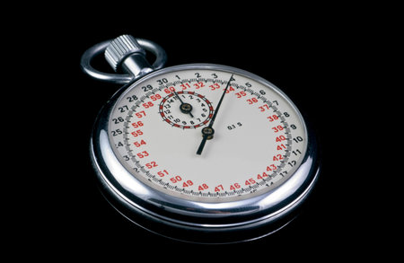 A macro shot of a stop watch taken on a black background.の写真素材