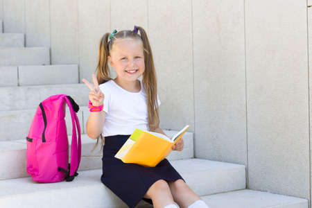girl with a textbook and a backpackの写真素材