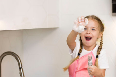 Helping hand. Cute Teenage Girl Help Her Mother In Washing Dishes At Family Kitchenの写真素材