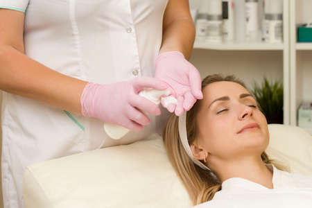 stage of facial cleansing at a cosmetologist's appointmentの写真素材