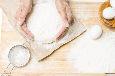 on the table is: a bowl of dough, flour, eggs, salt, sugar, strainer. Cooking baking
