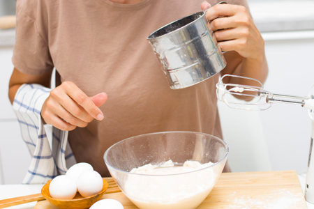 Preparation of the test. Ingredients on the table-wheat flour, eggs, salt. Electoral focusの写真素材