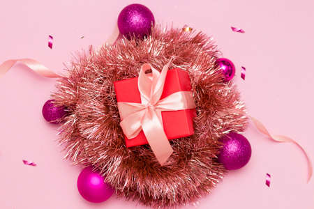 Happy new year 2021. Christmas toys, gift boxes, red cap, on a pink background. Christmas.の写真素材