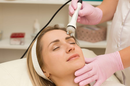 portrait of a young beautiful girl rf face lifting procedure. Face care and rejuvenation. Increased...