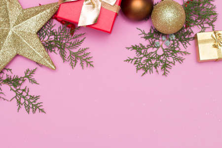 Happy new year 2021. Christmas toys, gift boxes, red cap, on a pink background. Christmas.の写真素材