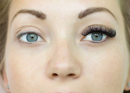 Eyelash extensions before and after, eyelashes, a beautiful woman with open eyes. Macro.