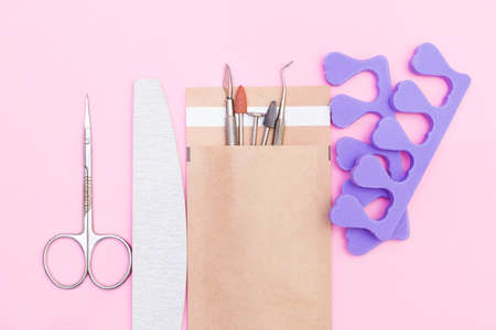 Top view of manicure and pedicure equipment, isolated on a pink backgroundの写真素材