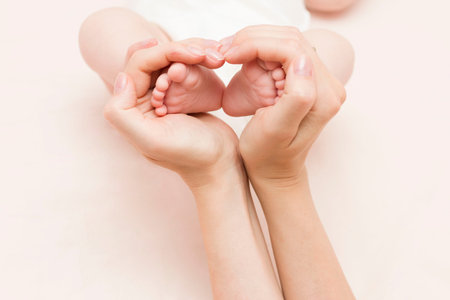 The baby's legs in the mother's hands are in the form of a hearth, a heart