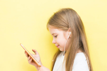 Little girl watching cartoons on her phoneの写真素材