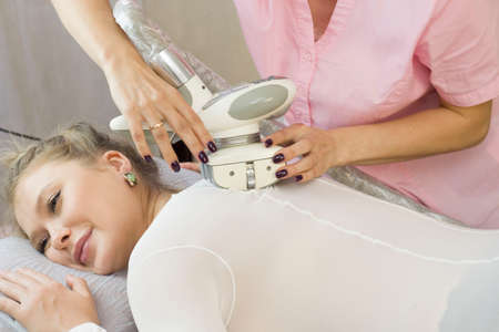 The masseur is preparing to do a hardware anti-cellulite massage in a beauty salon. Lpg massageの写真素材