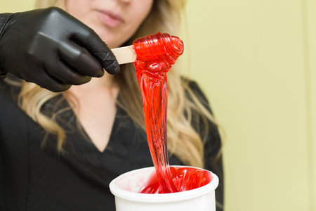shugaring paste in a jar on a spatula redの写真素材