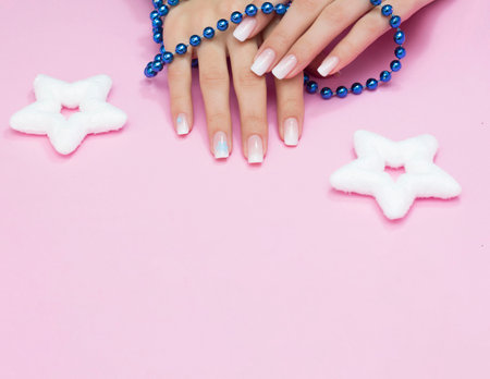 Beautiful gradient manicure. Snowflakes on the nails. The concept of a New Year's manicure.の写真素材