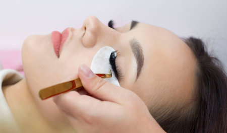Eyelash extensions. Artificial eyelashes. The girl in the salon is doing an eyelash extension...