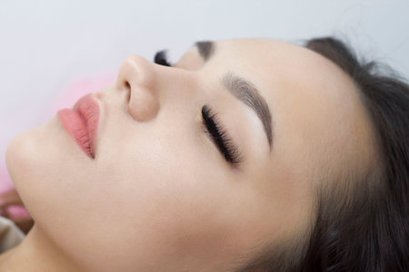 Eyelash extensions. Close-up of the eyes with thick black eyelashes. Macro. Expressive look