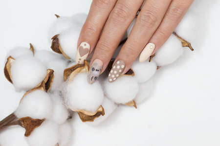 Manicure. Drawing on the nails. Nude nail polish.の写真素材