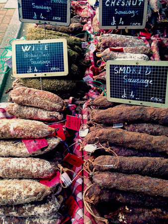 Selection of French dried sausages on a market stallの素材