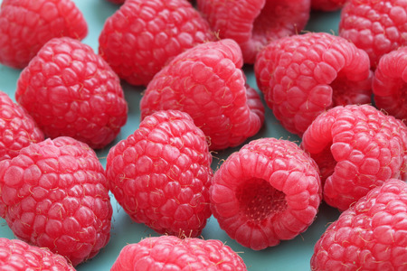Raspberries on blue backgroundの写真素材