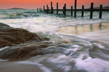 Rocks on the beach and wooden pier. Qingdao sceneryの写真素材