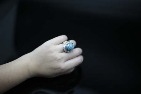 Turquoise rings and a woman's handの写真素材