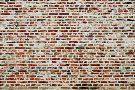 Brick wall horizontal background with red, orange and brown bricksの写真素材