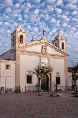 The church of Saint Mary Igreja Santa Maria in Lagos, Portugal. Beautiful summer sky above with small white clouds. Christian church in Algarve region.の写真素材