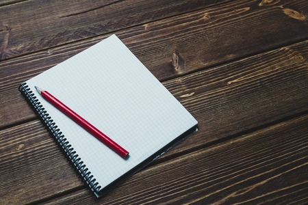 notebook with pencil on old  wooden table. Top view. Free space for designの写真素材