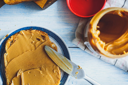Peanut butter sandwiches or toasts  on light wooden background