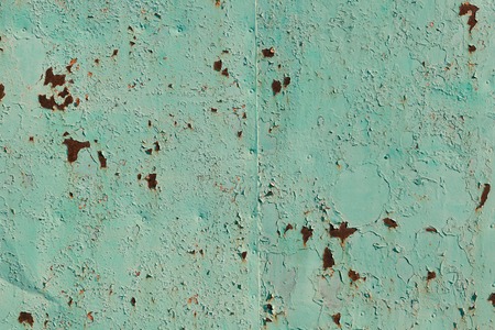 Old green cracked paint on the old metal backgroundの写真素材