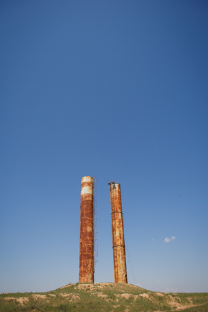 old rusty chimney on the hill on a summer dayの写真素材