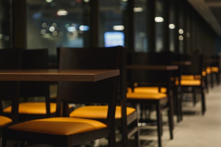 rows of tables and chairs in empty cafe. Close-upの写真素材