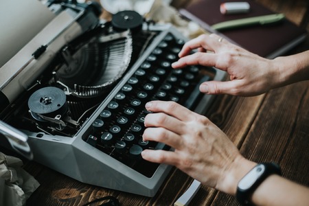 Writer typing with retro writing machine. View from above.の写真素材