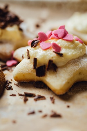 Colorful cookie with chocolate on the top. Vertical studio shot.の写真素材