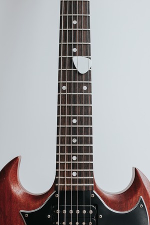 Crop shot o wooden guitar on white background.の写真素材
