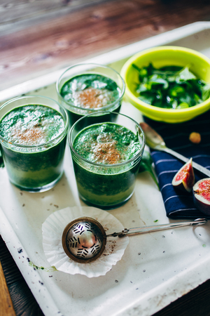 From above crop shot of green smoothies with leaves of fresh mint on the kitchen deskの写真素材