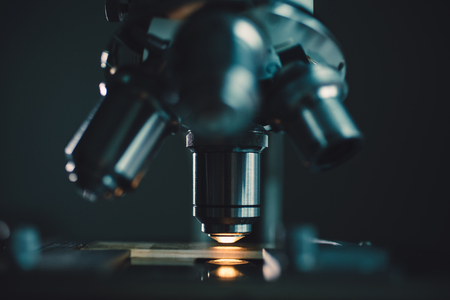 Close-up shot of microscope with metal lens at laboratory.の写真素材