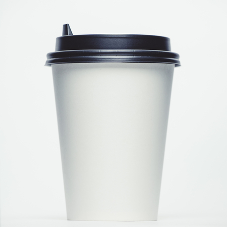 Mockup image of paper cup with cap on clean bacgroundの写真素材