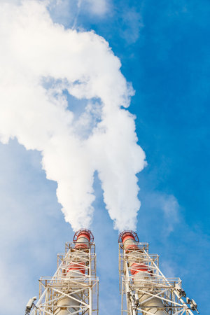 Stream of smoke from the chimney of factory in the industrial district