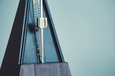 Color shot of a vintage metronome, on gray background.の写真素材