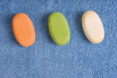 colorful soaps, blue towel background