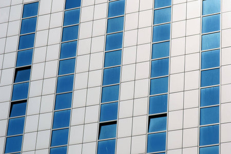 Wall of modern apartment skyscraper. Blue and white