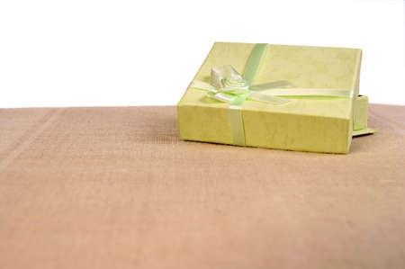 Green mini gift box with ribbon isolated on white backgroundの写真素材