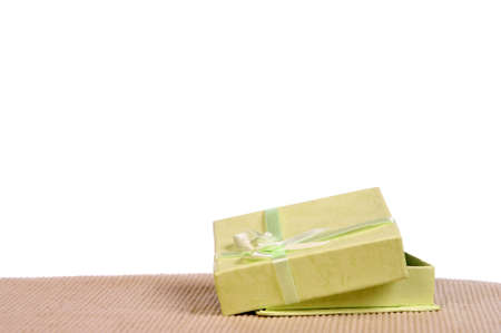 Green mini gift box with ribbon isolated on white backgroundの写真素材