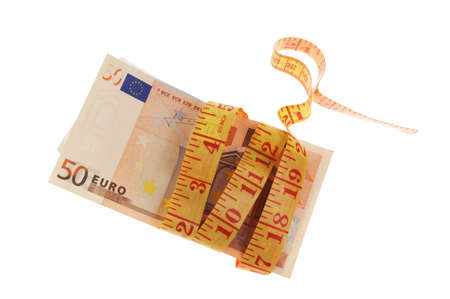 Measuring tape wrapped around the roll of euro banknotes の写真素材