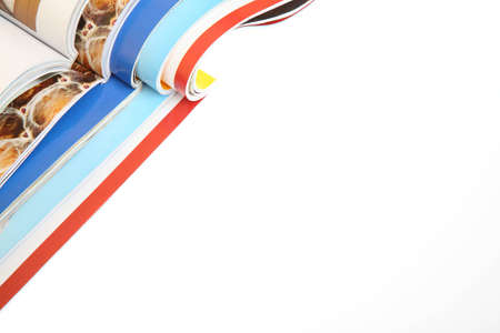 stack of opened magazines isolated on whiteの写真素材