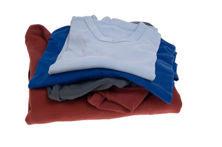 Stack of shirts in different colors isolated on white