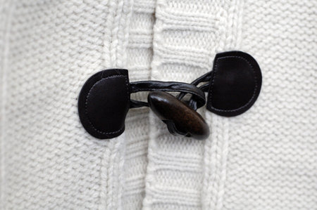 Black button on white textile